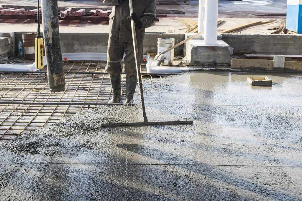 photo of a worker laying concrete