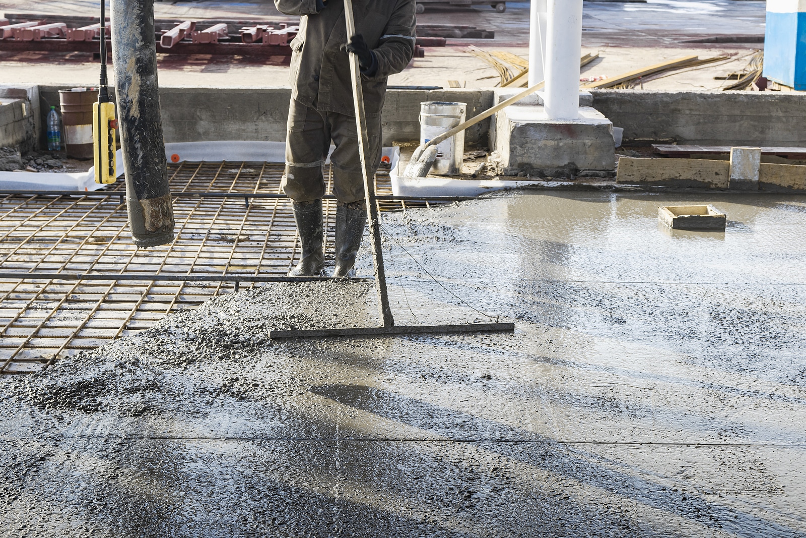 photo of a worker laying concrete