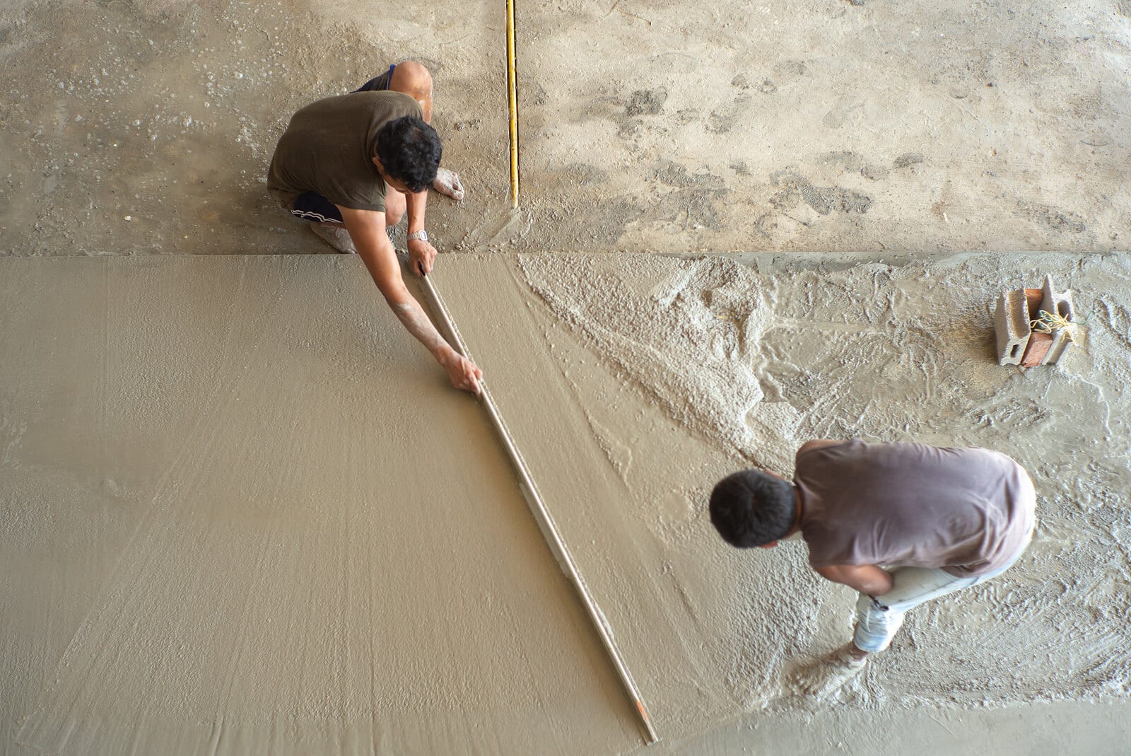 Top view of workers laying concrete
