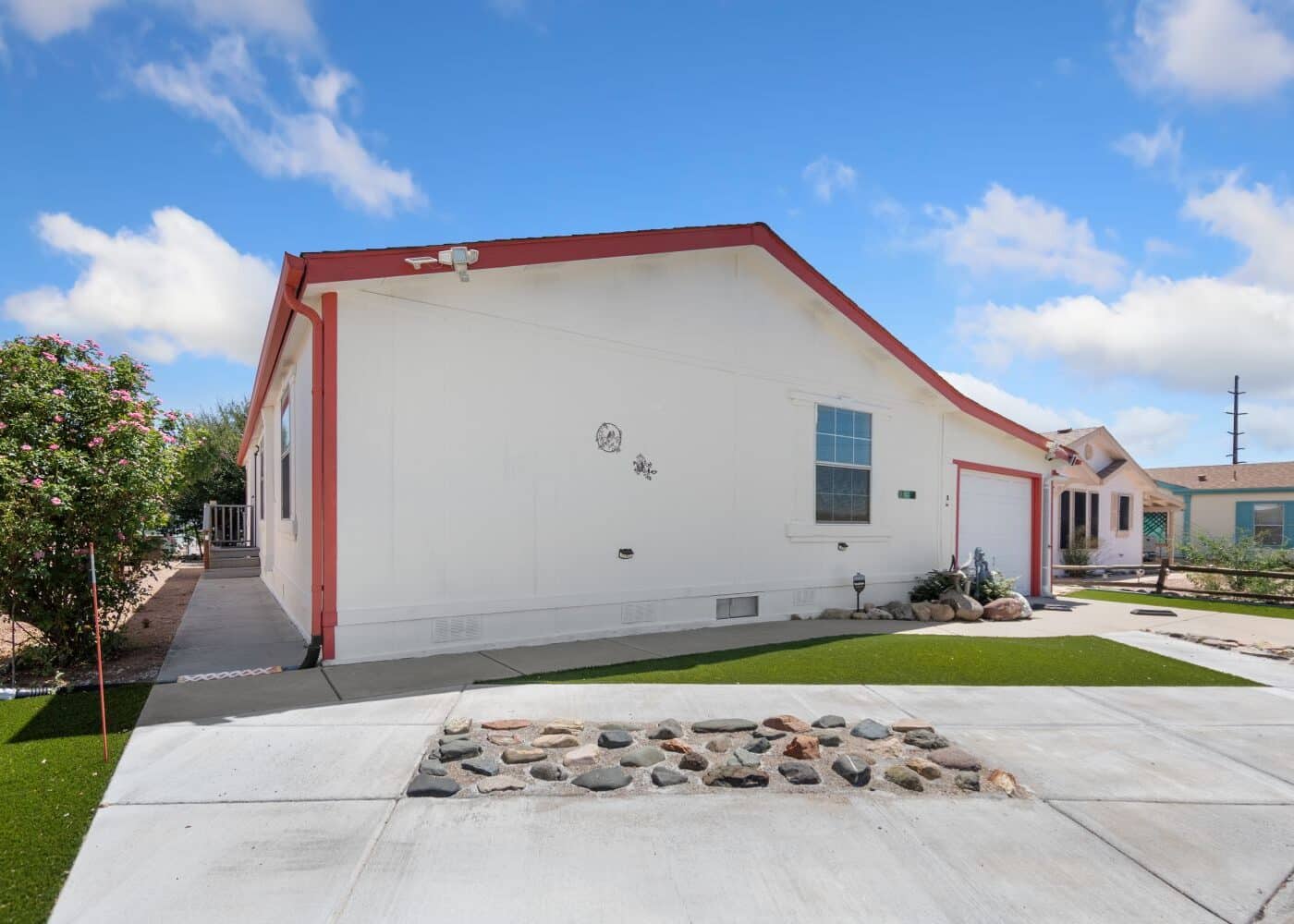 Outside of property with white slab concrete patio. 